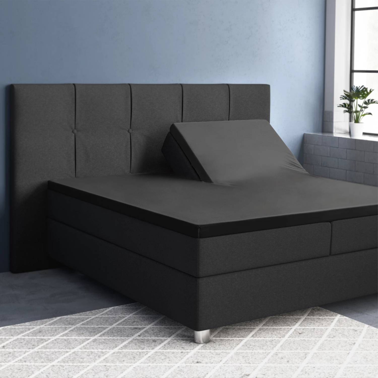 Verstelbaar bed met grijze bekleding in slaapkamer